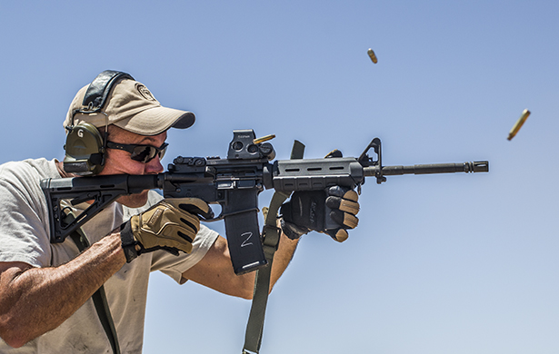 A man firing an AR-15 with Federal brass cased ammunition.