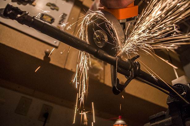 A saw cuts into the barrel of an AR-15 during the steel vs. brass test.