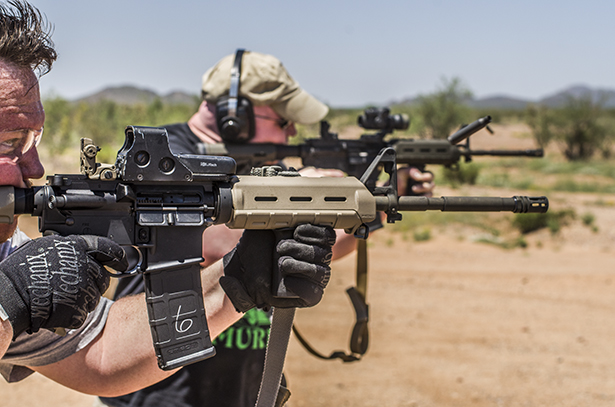 A photo showing two men firing steel cased ammunition.